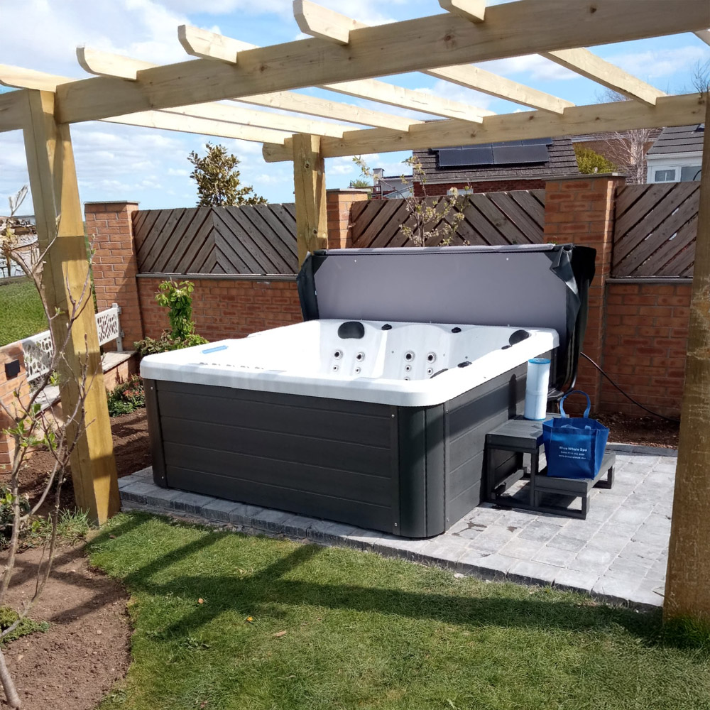 Luxurious hot tub installation by Bontrager Pools in a serene backyard setting